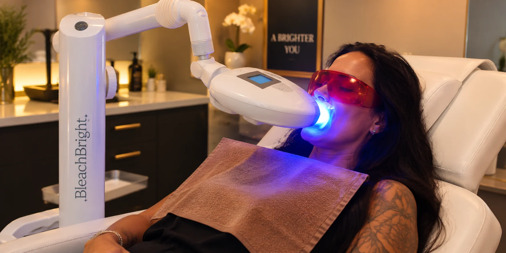 Client relaxing during a professional mobile teeth whitening treatment